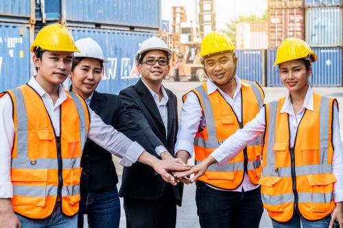 Group of employees and management team wearing logistic uniforms
